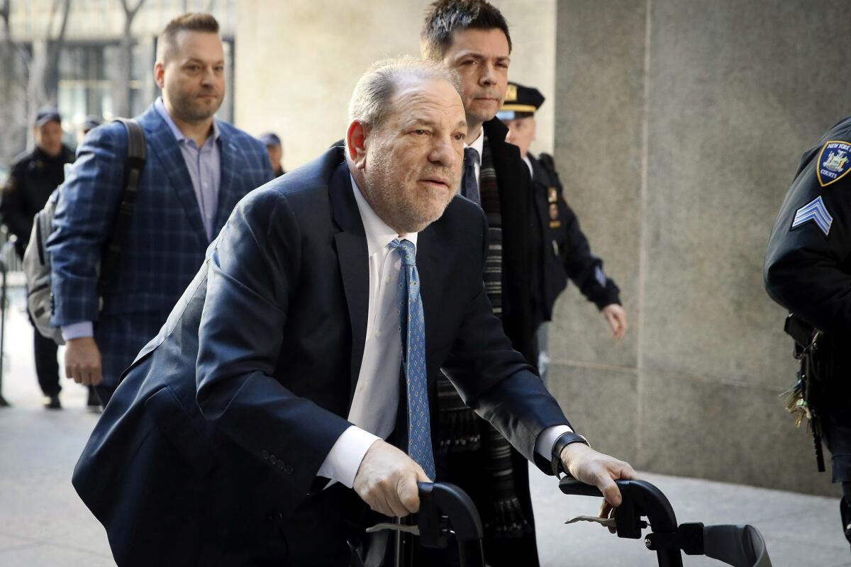 Harvey Weinstein uses a walker outside a Manhattan courthouse.