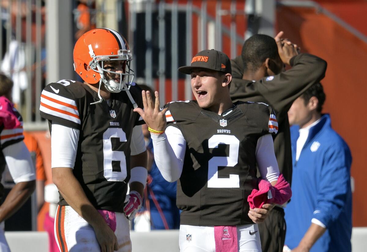 Cleveland Browns backup quarterback Johnny Manziel, right, talks with starter Brian Hoyer on the sideline Sunday.