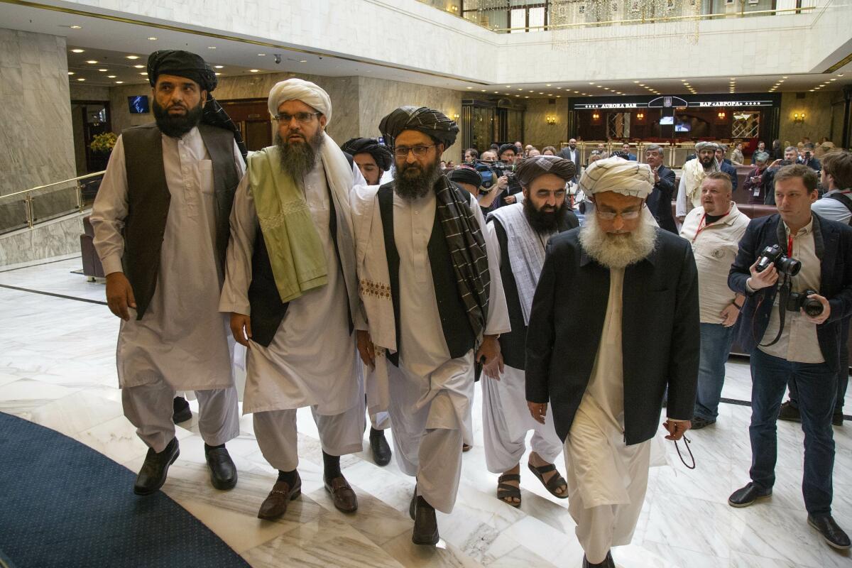 Mullah Abdul Ghani Baradar, the Taliban's top political leader, third from left, arrives with other members of the Taliban delegation for talks in Moscow in May 2019.