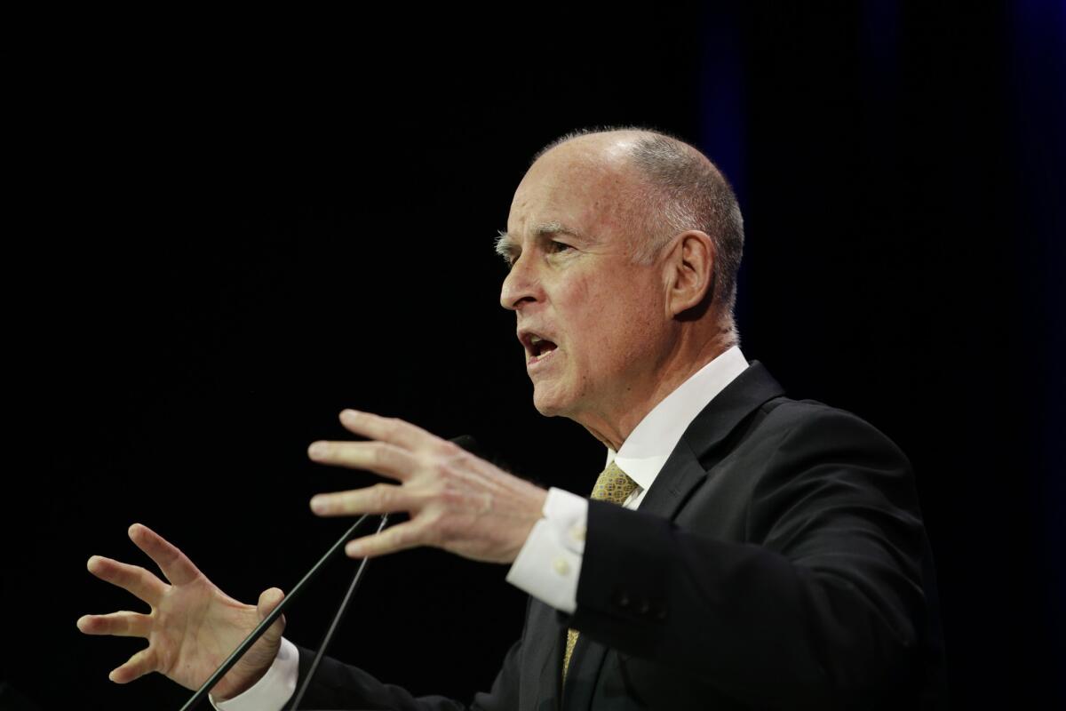 California Gov. Jerry Brown, shown speaking Saturday at the state Democratic Party convention, faces a lawsuit from church groups and homeownership advocates over mortgage settlement money.