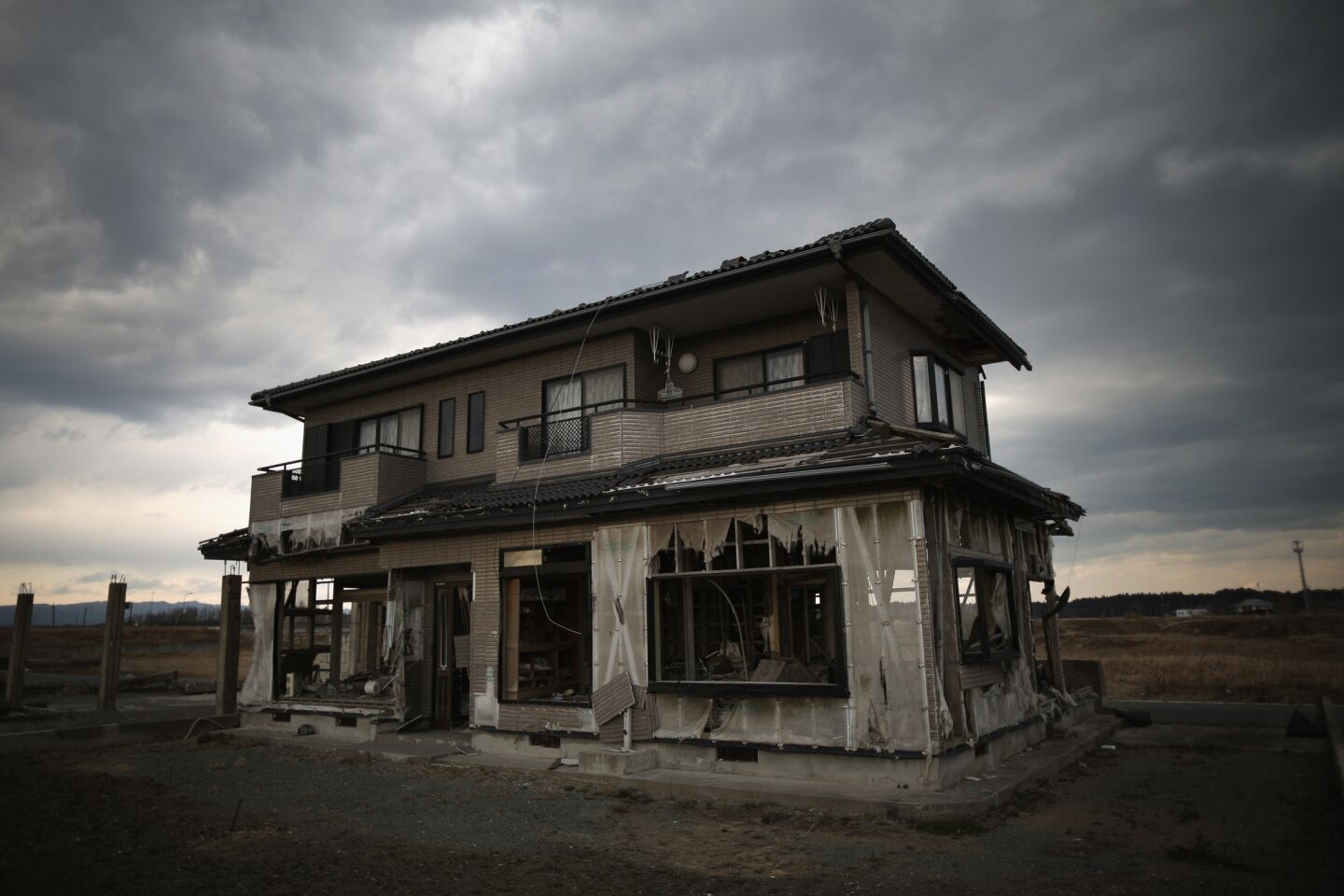 A house sits on the scarred landscape inside the exclusion zone close to the devastated Fukushima Daiichi nuclear power plant in Namie, Japan. The area is closed to residents because of radiation contamination from the Fukushima nuclear disaster.