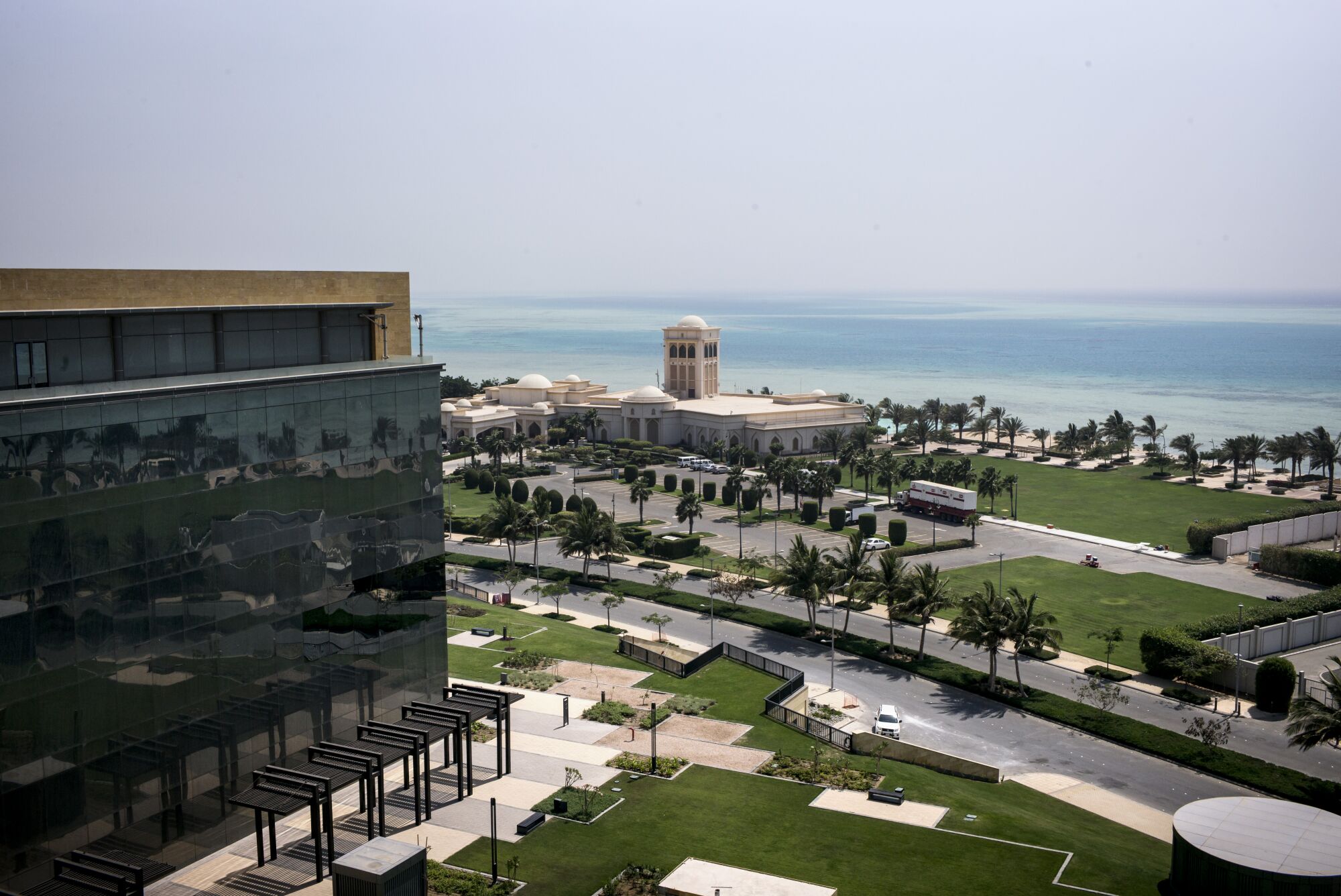 Buildings sit amid trees and grassy areas on the Saudi coast