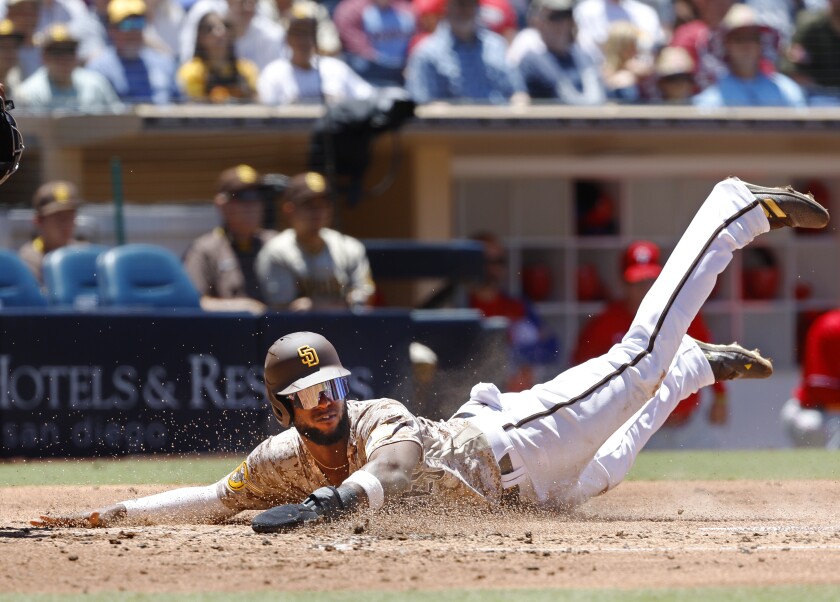 Padres outfielder Jurickson Profar scores in the first inning against the Phillies on Sunday at Petco Park.