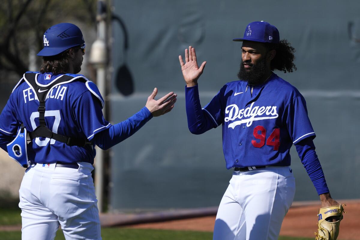 Dodgers starting pitcher Andre Jackson, right, gives a high-five to catcher Hunter Feduccia.