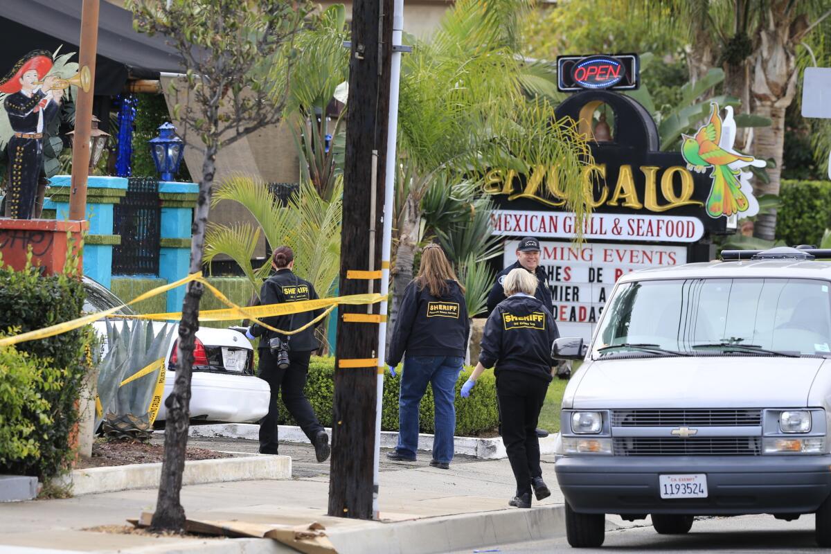 Three people were hit, one fatally, by gunshots in a Santa Ana restaurant.