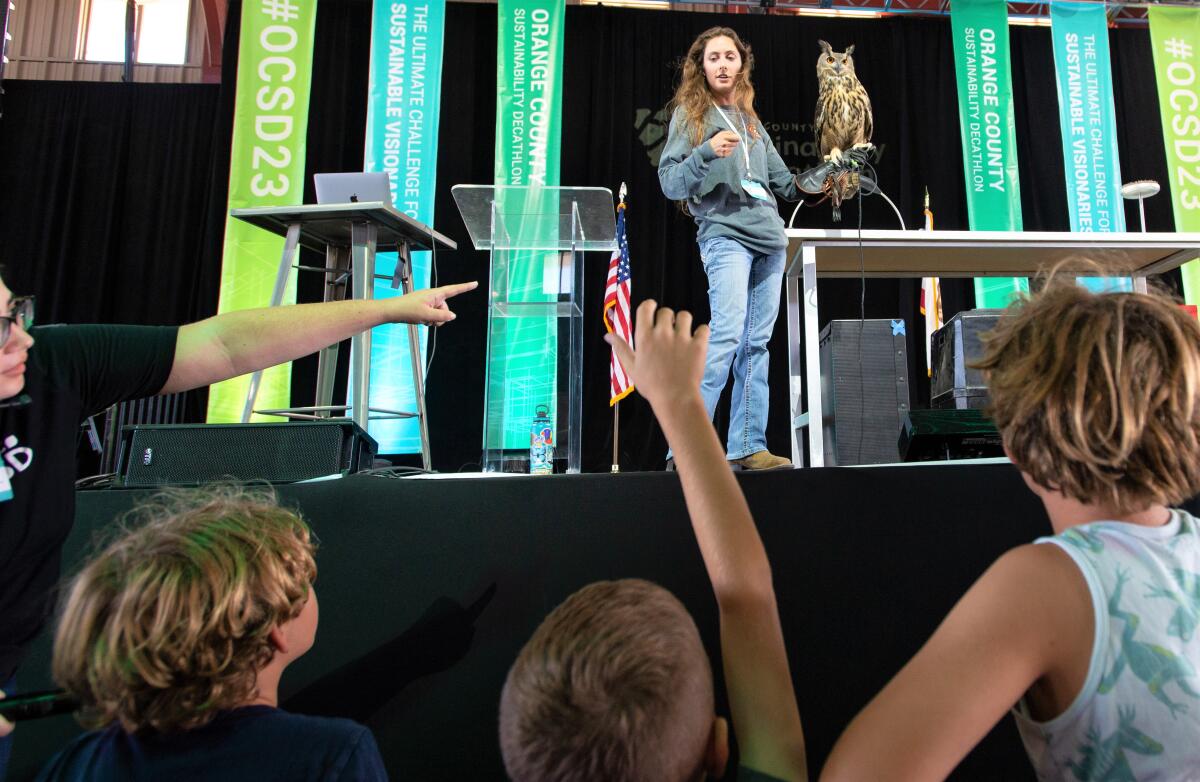 Children ask questions at a sustainable pest control demonstration at the O.C. Sustainability Decathlon on Oct. 14.