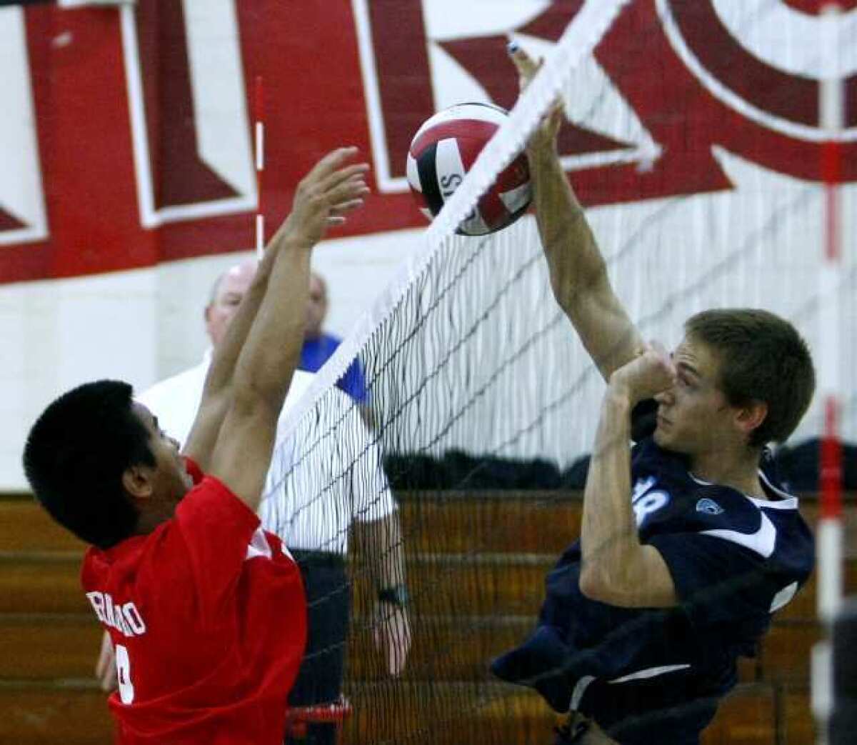 Glendale High's #9 Victor Bernardino, left, blocks a kill by Crescenta Valley High's #18 Freedom Tripp, right, during home game in Glendale on Friday, April 5, 2013. (Raul Roa/Staff Photographer)