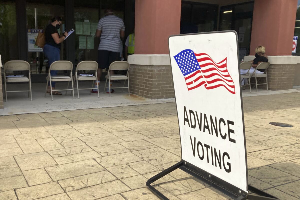 FILE - An advanced voting sign is seen, in Marietta, Ga. on May 19, 2022 during early-in person voting before Georgia's May 24, 2022 primary. Changes in Georgia state law have left less time to vote early before the June 21, 2022 runoff. (AP Photo/Mike Stewart, File)