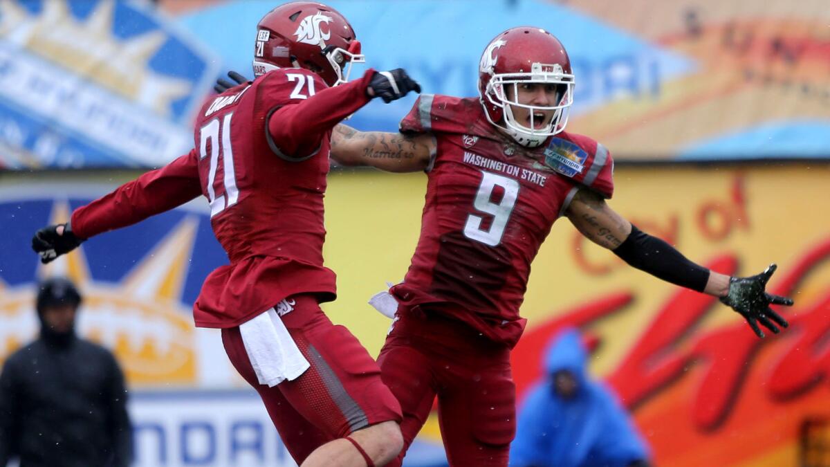 Washington State receiver Gabe Marks (9) celebrates with teammate River Cracraft after scoring a touchdown against Miami in the first half Saturday.