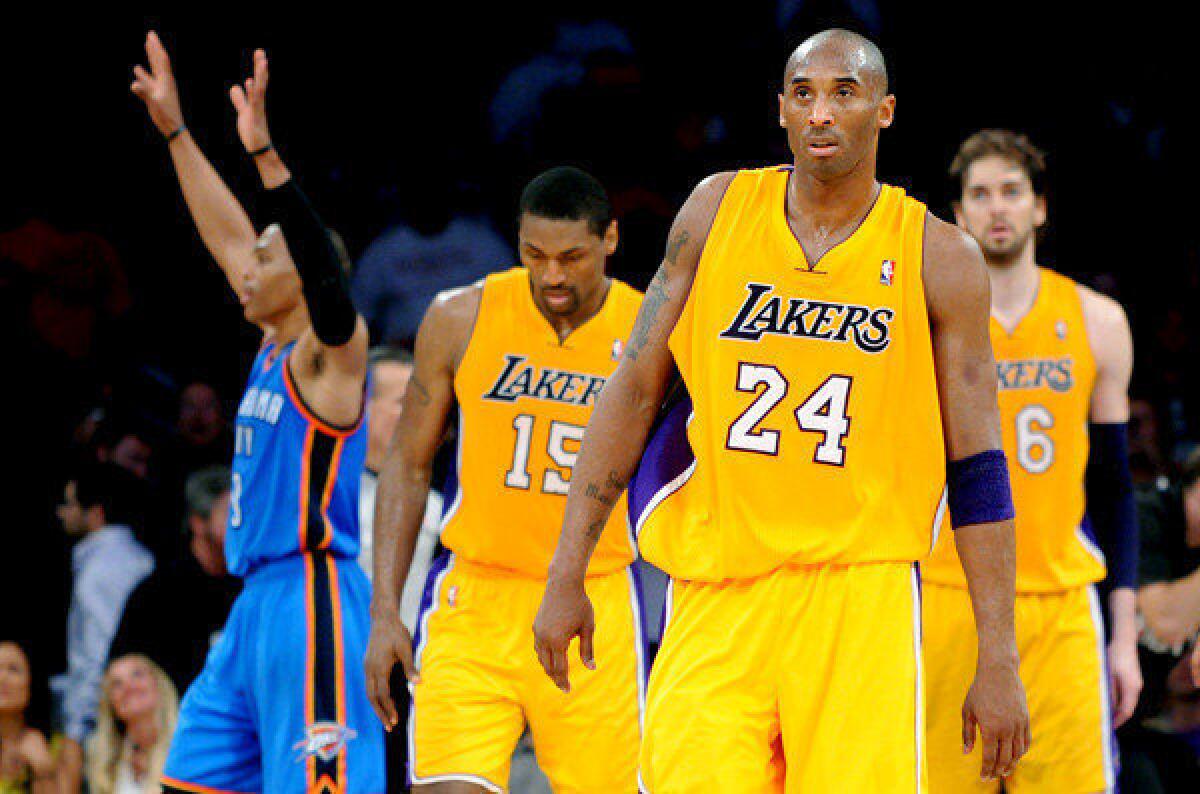 Kobe Bryant, Metta World Peace and Pau Gasol walk off the court after the Lakers 103-100 Game 4 loss to the Thunder.