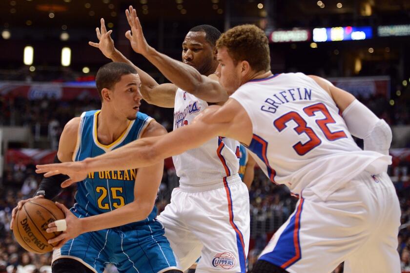 Austin Rivers looks to pass around the defense of the Clippers' Willie Green and Blake Griffin while playing for New Orleans.