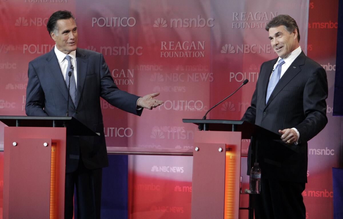 Former Massachusetts Gov. Mitt Romney, left, and Texas Gov. Rick Perry attacked each other's record for creating jobs in their states during a Republican presidential debate.