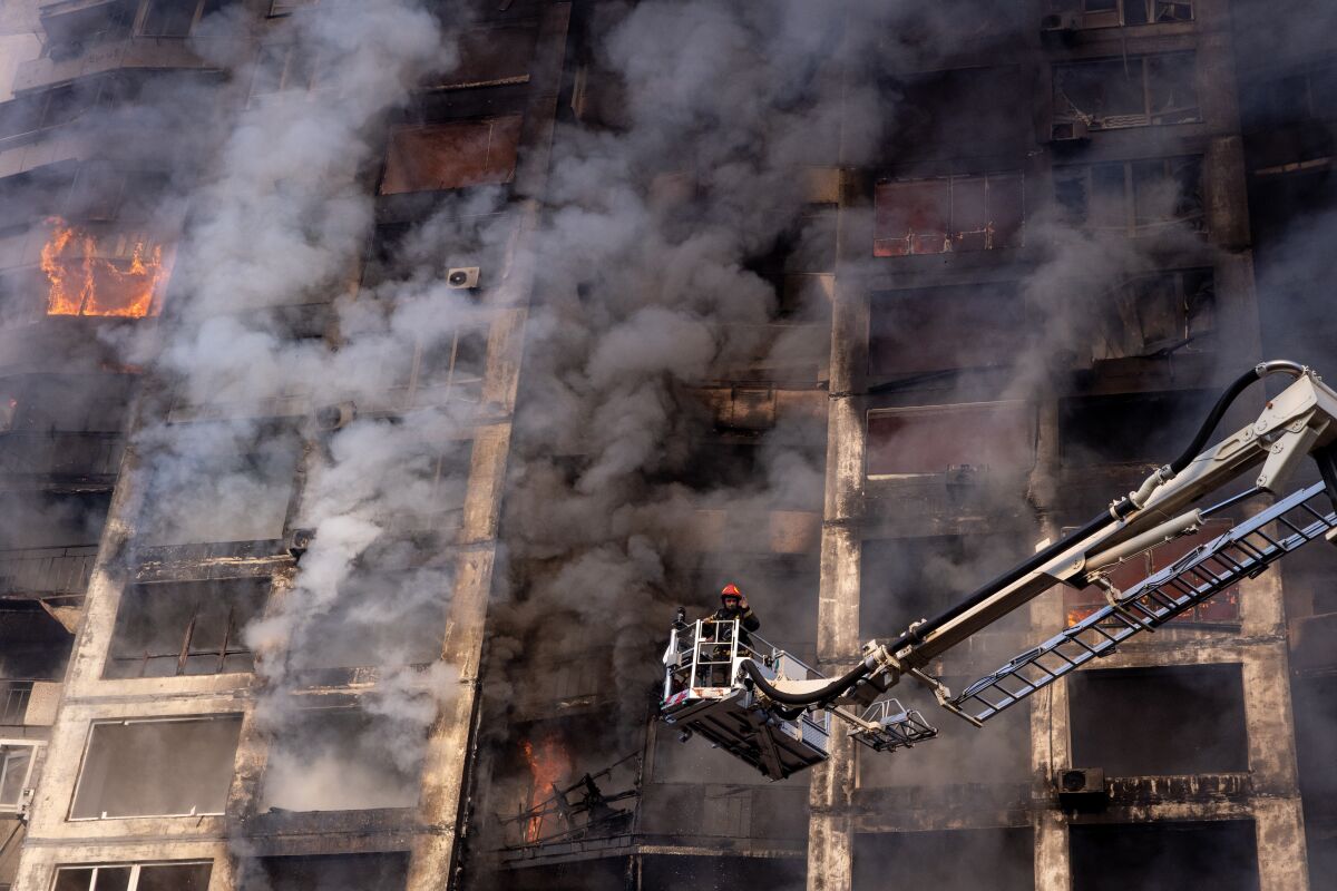Firefighters work to extinguish a fire at a residential apartment building 