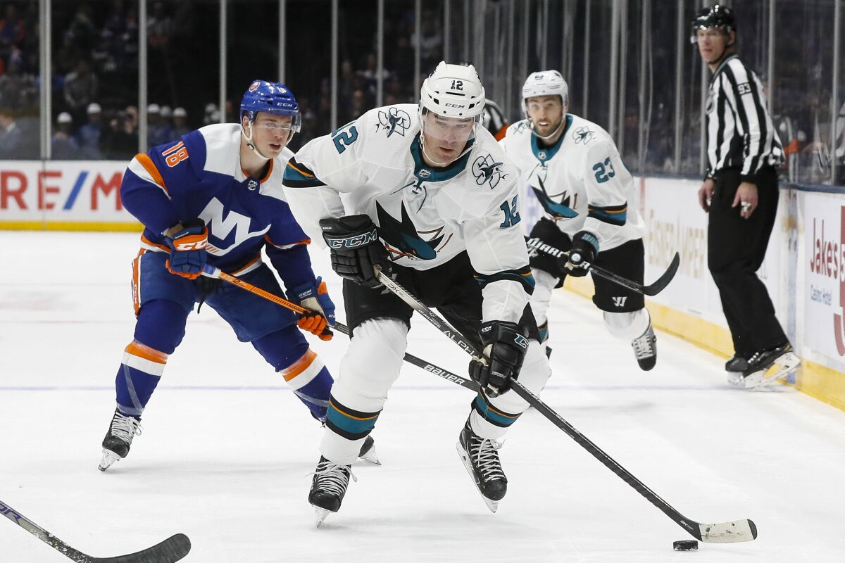 FILE - In this Feb. 23, 2020, file photo, San Jose Sharks left wing Patrick Marleau (12) looks to pass during the first period of an NHL hockey game against the New York Islanders in Uniondale, N.Y. Marleau rejoined San Jose on Tuesday, Oct. 13, 2020, signing a one-year deal worth the league minimum of $700,000. (AP Photo/John Minchillo, File)