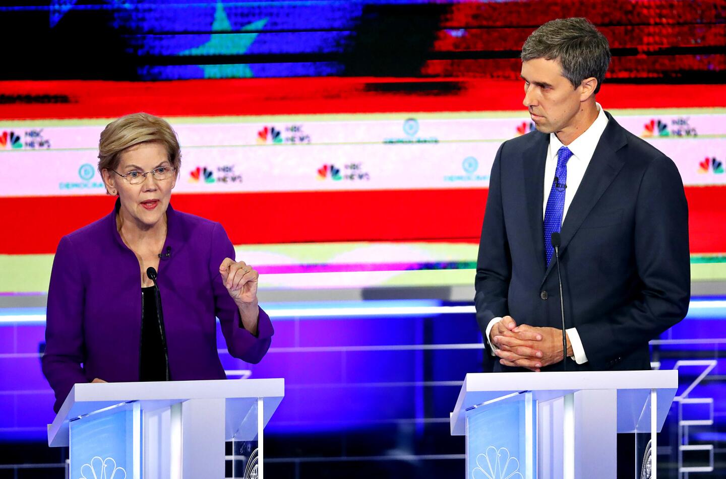 Democratic presidential candidate Sen. Elizabeth Warren, D-Mass., answers a question, as former Texas Rep. Beto O'Rourke listens during a Democratic primary debate hosted by NBC News at the Adrienne Arsht Center for the Performing Art, Wednesday, June 26, 2019, in Miami.