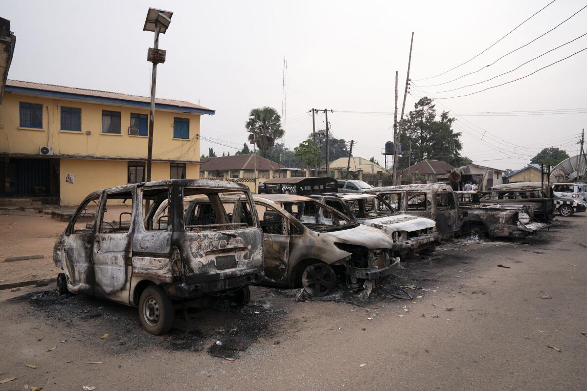 Burned vehicles are parked outside the police command headquarters in Owerri, Nigeria, on Monday, April 5, 2021. Hundreds of inmates escaped from a prison in the southeastern Nigerian city after a series of coordinated attacks, according to government officials. (AP Photo/David Dosunmu)