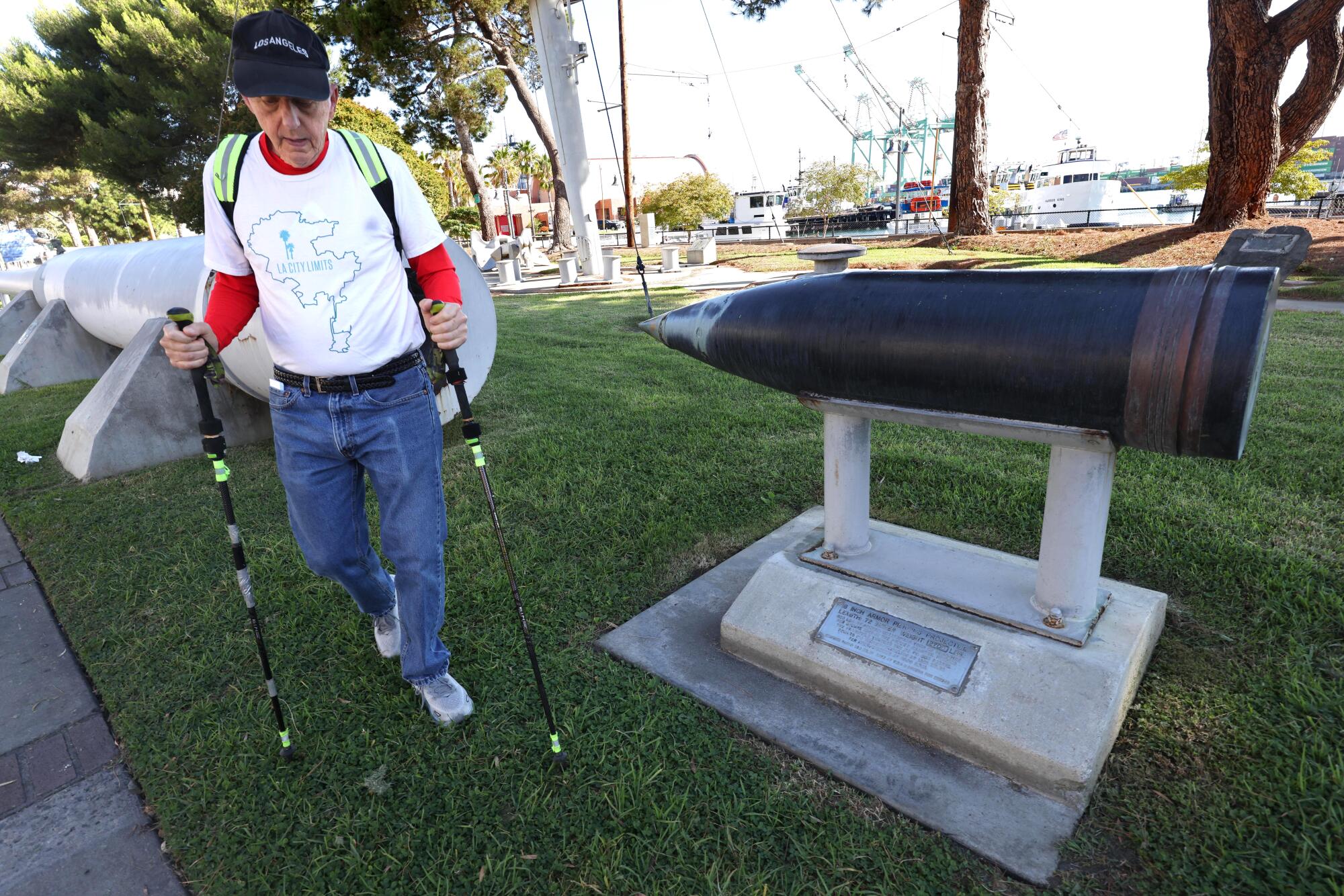 Dr. Roy Parts walks past a display of a projectile that pierced San Pedro.