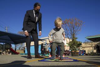 North Hollywood, CA - February 17: LAUSD new superintendent Alberto M. Carvalho watches 3-year-old Julian Elwell play hopscotch during a visit to Fair Avenue Early Education Center on Thursday, Feb. 17, 2022 in North Hollywood, CA. (Irfan Khan / Los Angeles Times)