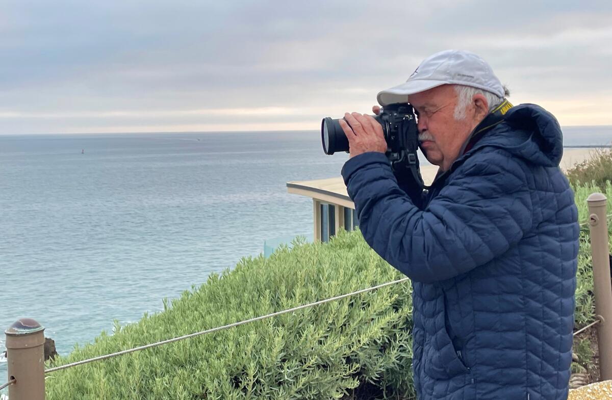 Richard "Scoop" Koehler takes a photo off the Pacific shore. 
