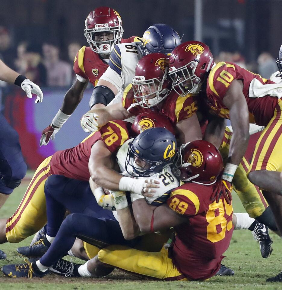 The USC defense clamps down on Cal running back Patrick Laird in the fourth quarter.