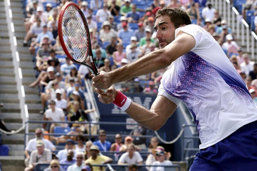 Marin Cilic returns a shot against Mikhail Kukushkin during their third-round match at the U.S. Open on Friday.