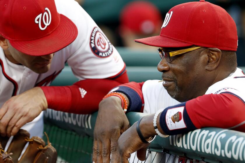 Nationals Manager Dusty Baker chats with infielder Danny Espinosa during their game Tuesday.