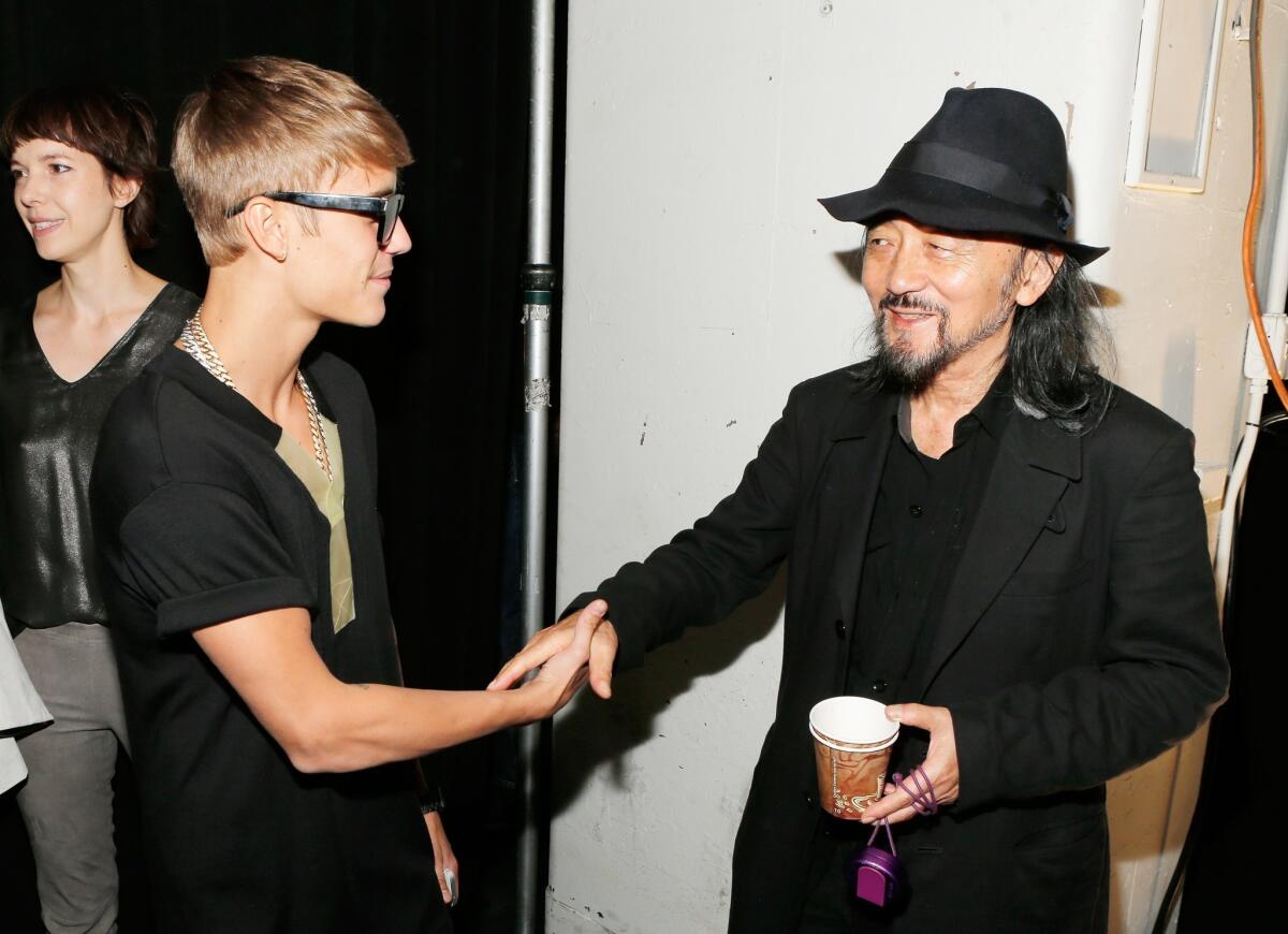 Justin Bieber, left, meets fashion designer Yohji Yamamoto backstage at the Y-3 Spring/Summer 2014 show during Mercedes-Benz Fashion Week in New York City.