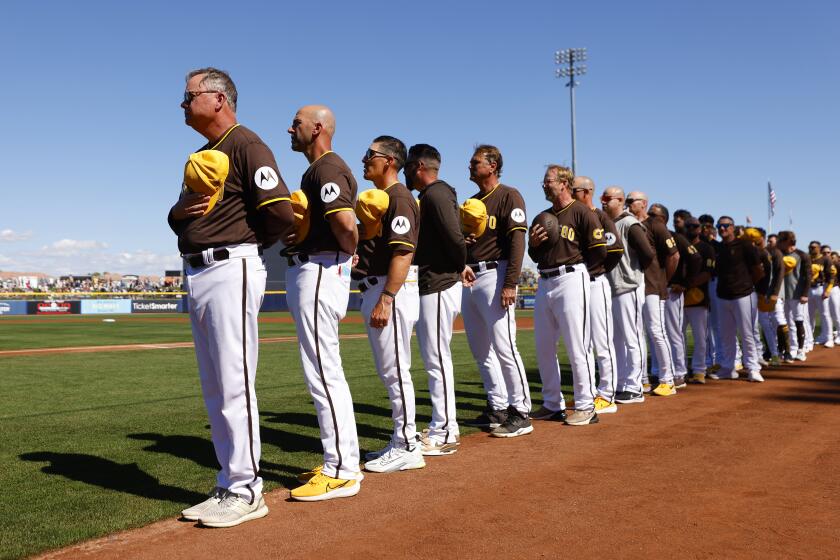 PEORIA, AZ - February 22: San Diego Padres manager Mike Shildt stands with the team for the national anthem before a spring training game against the Los Angeles Dodgers in Peoria, AZ on February 22, 2024. (K.C. Alfred / The San Diego Union-Tribune)