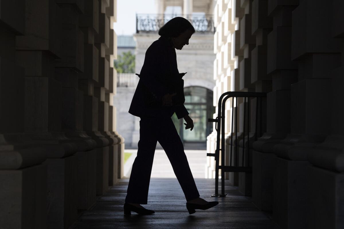 Sen. Dianne Feinstein (D-Calif.) seen in silhouette walking outside the Capitol.