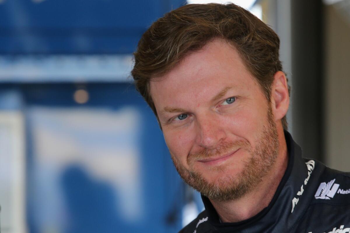 Dale Earnhardt Jr., driver of the #88 Nationwide Chevrolet, stands in the garage area during practice for the NASCAR Sprint Cup Series Quaker State 400 at Kentucky Speedway on July 7.
