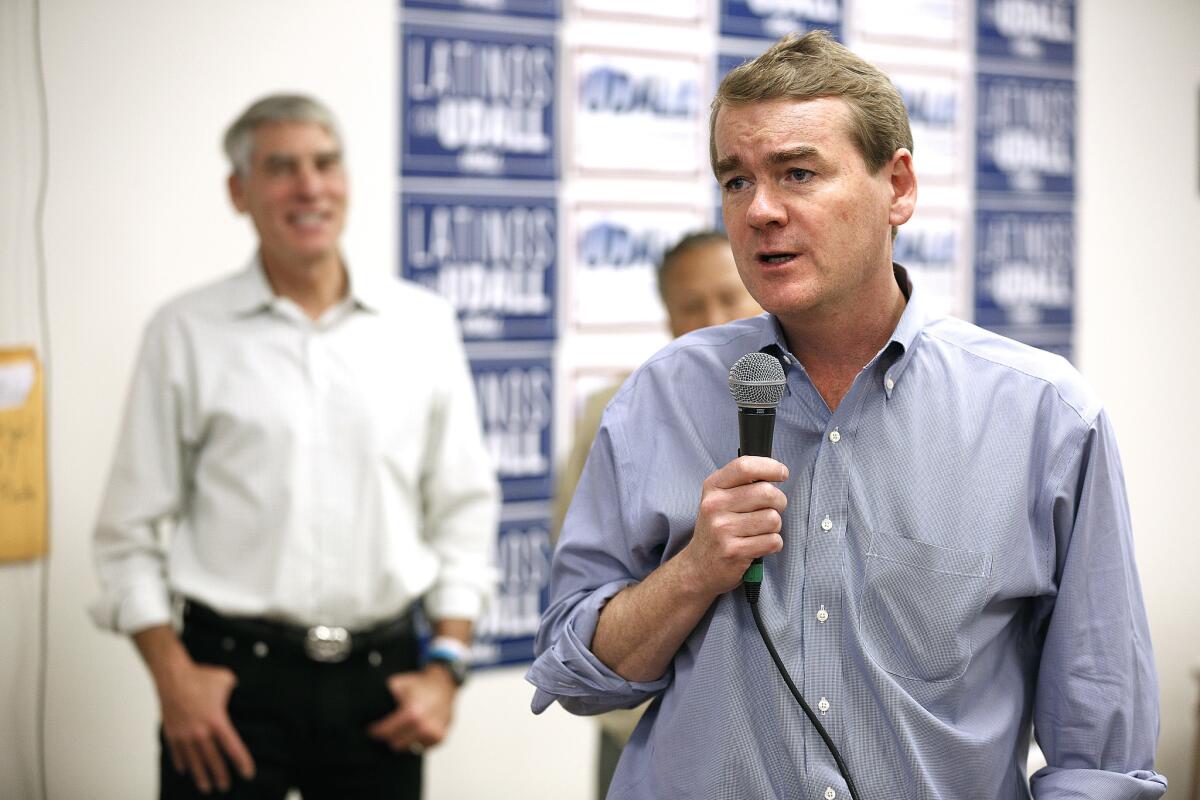 U.S. Sen. Michael Bennet, right, was joined on the campaign trail by former Sen. Mark Udall in October 2014.
