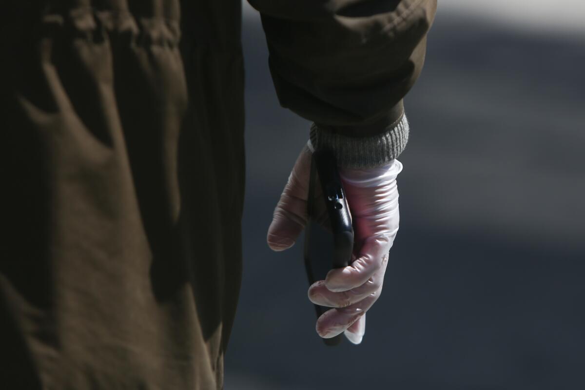 An 81-year-old man wearing gloves in Los Angeles