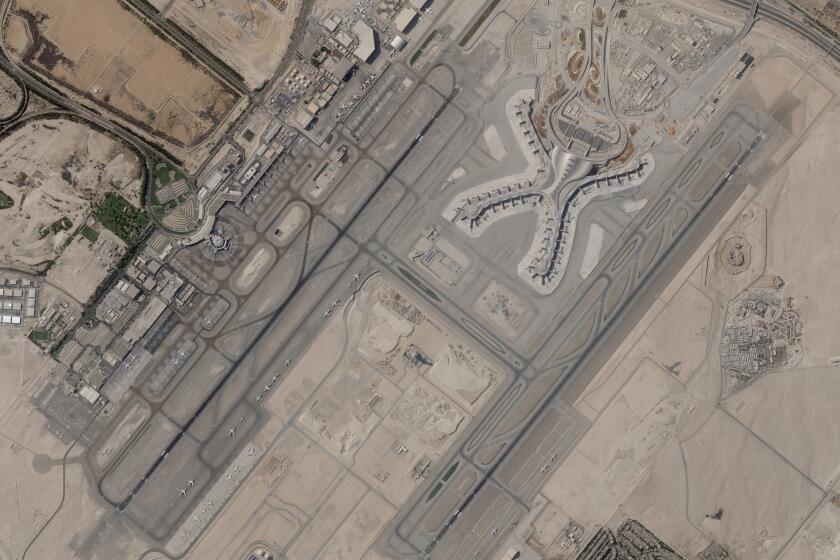 In a satellite photo by Planet Labs PBC, Abu Dhabi International Airport is seen Dec. 8, 2021. A suspected drone attack by Yemen's Houthi rebels targeting a key oil facility in Abu Dhabi killed three people and sparked a separate fire at Abu Dhabi's international airport on Monday, Jan. 17, 2022, police said. (Planet Labs PBC via AP)