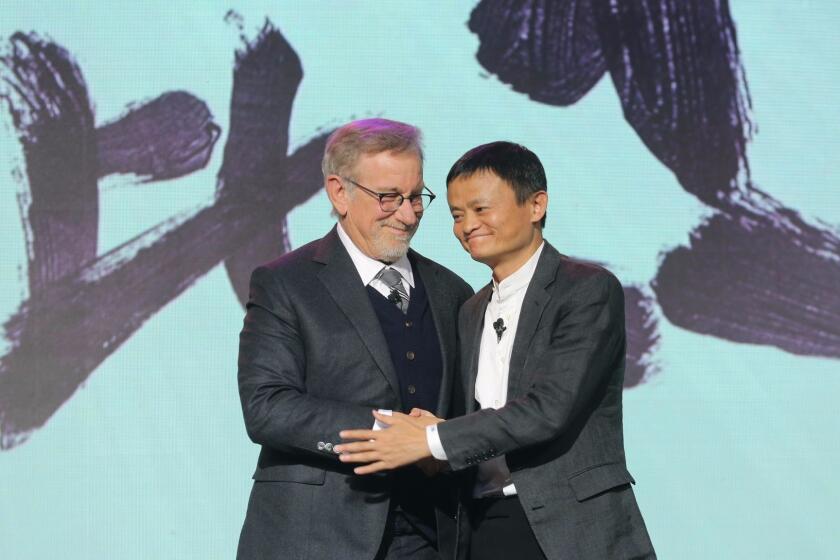 Steven Spielberg joins Alibaba Group's Jack Ma at a press event in Beijing.