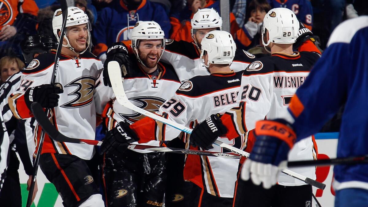 The Ducks celebrate a second-period goal by Kyle Palmieri, second left, during a 3-2 victory over the New York Islanders on Saturday.