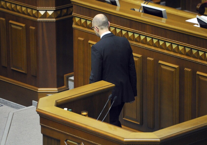 Arseny Yatsenyuk leaves the podium in Ukraine's parliament Thursday after announcing his resignation as prime minister.