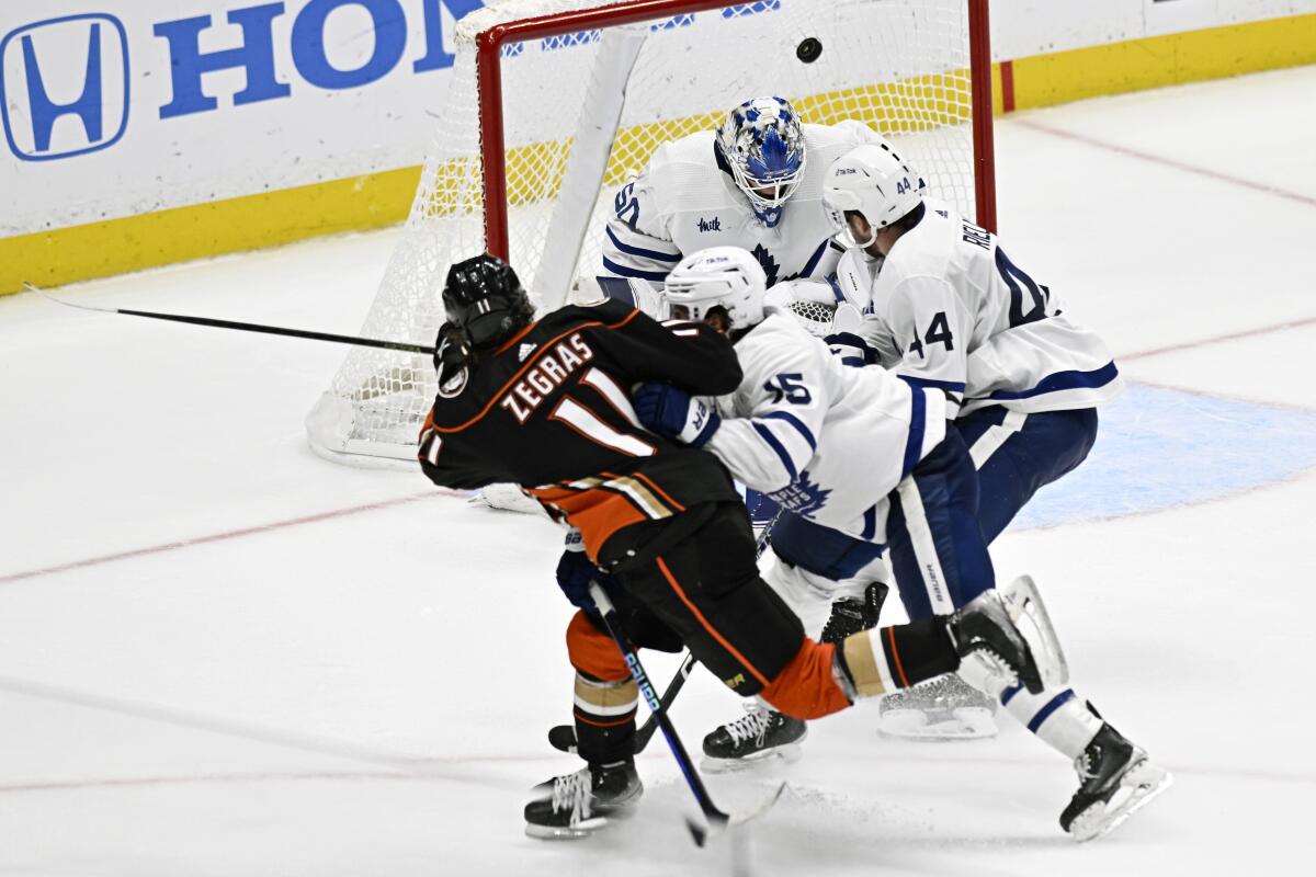 Ducks forward Trevor Zegras scores past Toronto Maple Leafs goaltender Erik Kallgren.