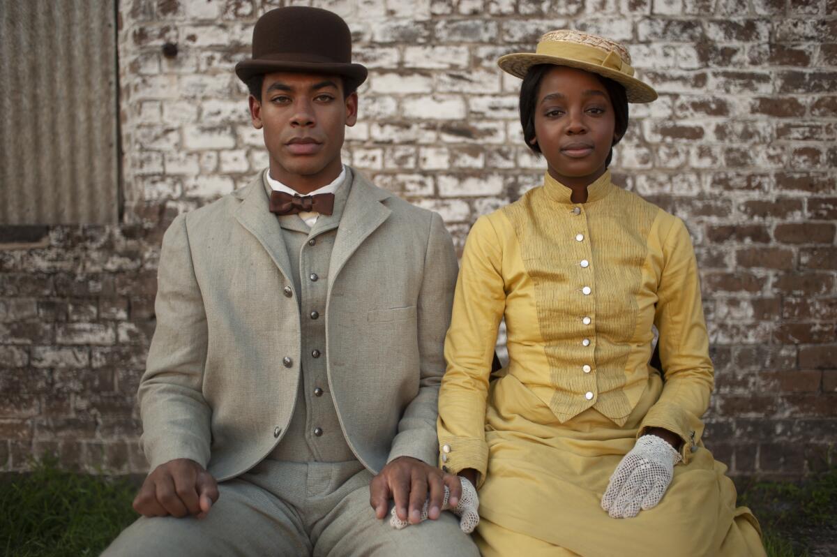 Aaron Pierre and Thuso Mbedu sitting together in "The Underground Railroad."