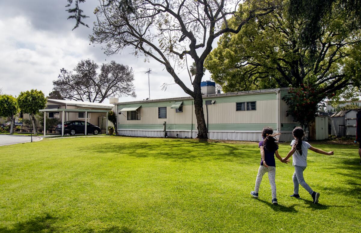 Young girls play together at Bell Mobile Home Park 