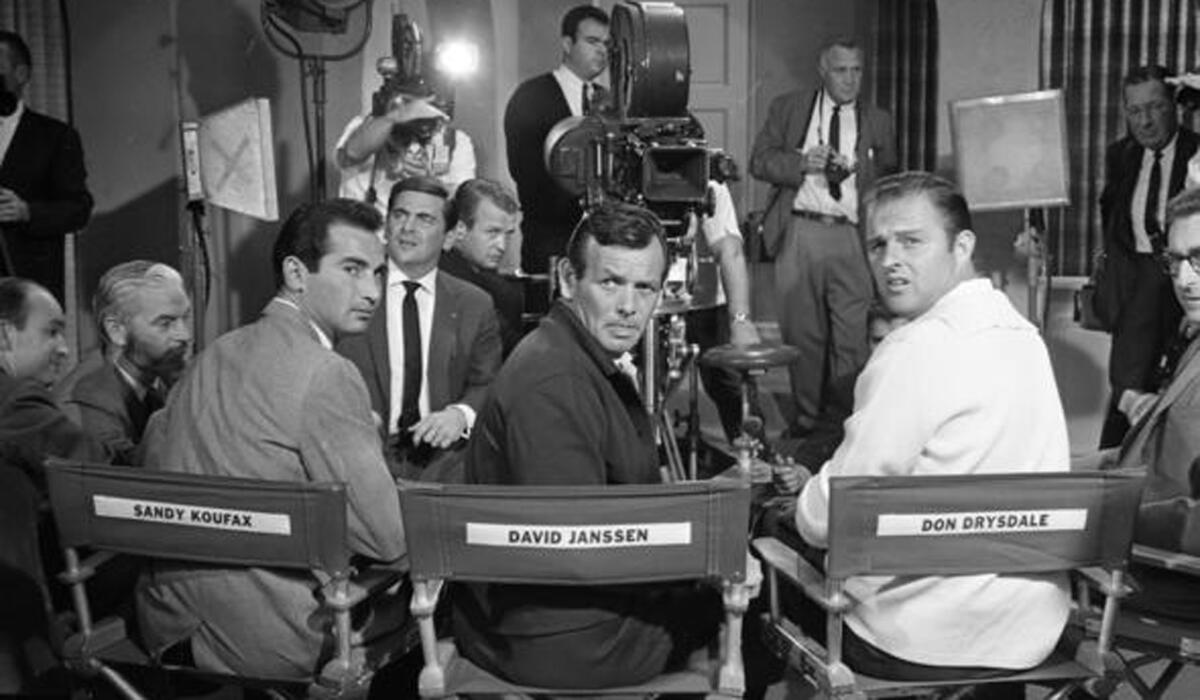 Dodgers pitcher Sandy Koufax, actor David Janssen and Dodger pitcher Don Drysdale sit on the set of a movie for a news conference in 1966 when Koufax and Drysdale were holding out for better contracts from the Dodgers.