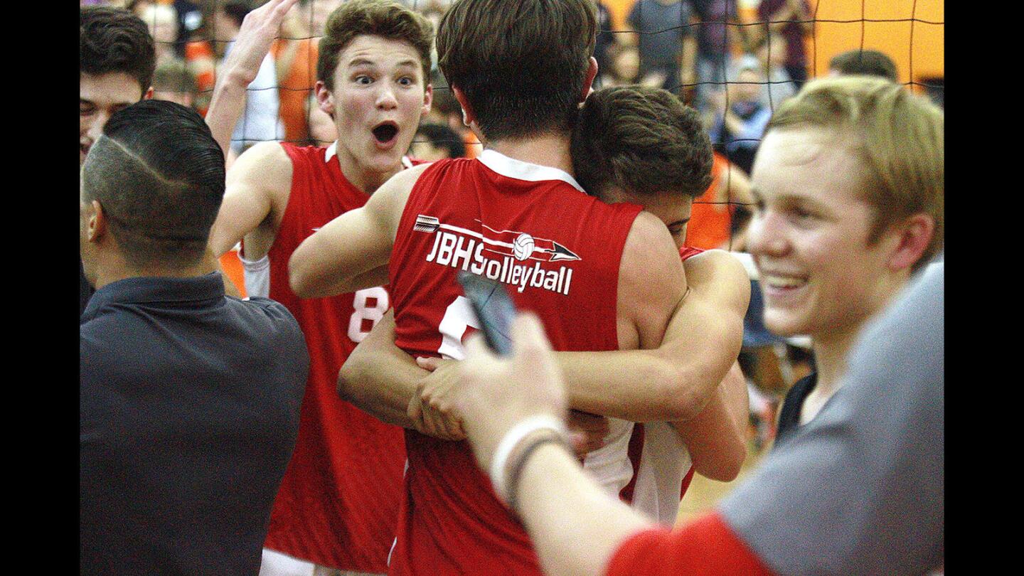 Burroughs' Jarrett Malone (8) reacts to victory with teammate Conner Ludlum as they celebrate with their team after defeating South Pasadena in a CIF semifinal boys' volleyball match at South Pasadena High School on Wednesday, May 18, 2016. Burroughs won the match 3-0.