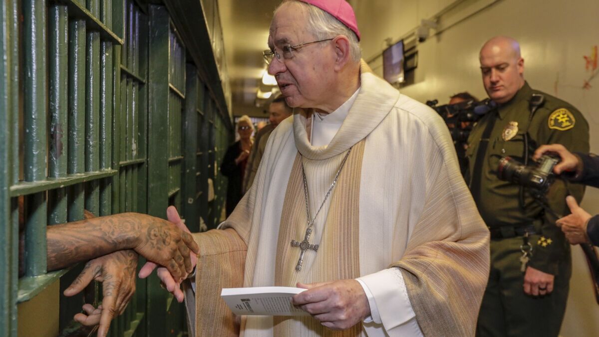 Archbishop Jose H. Gomez visits with inmates at the Men's Central Jail after Christmas Mass.