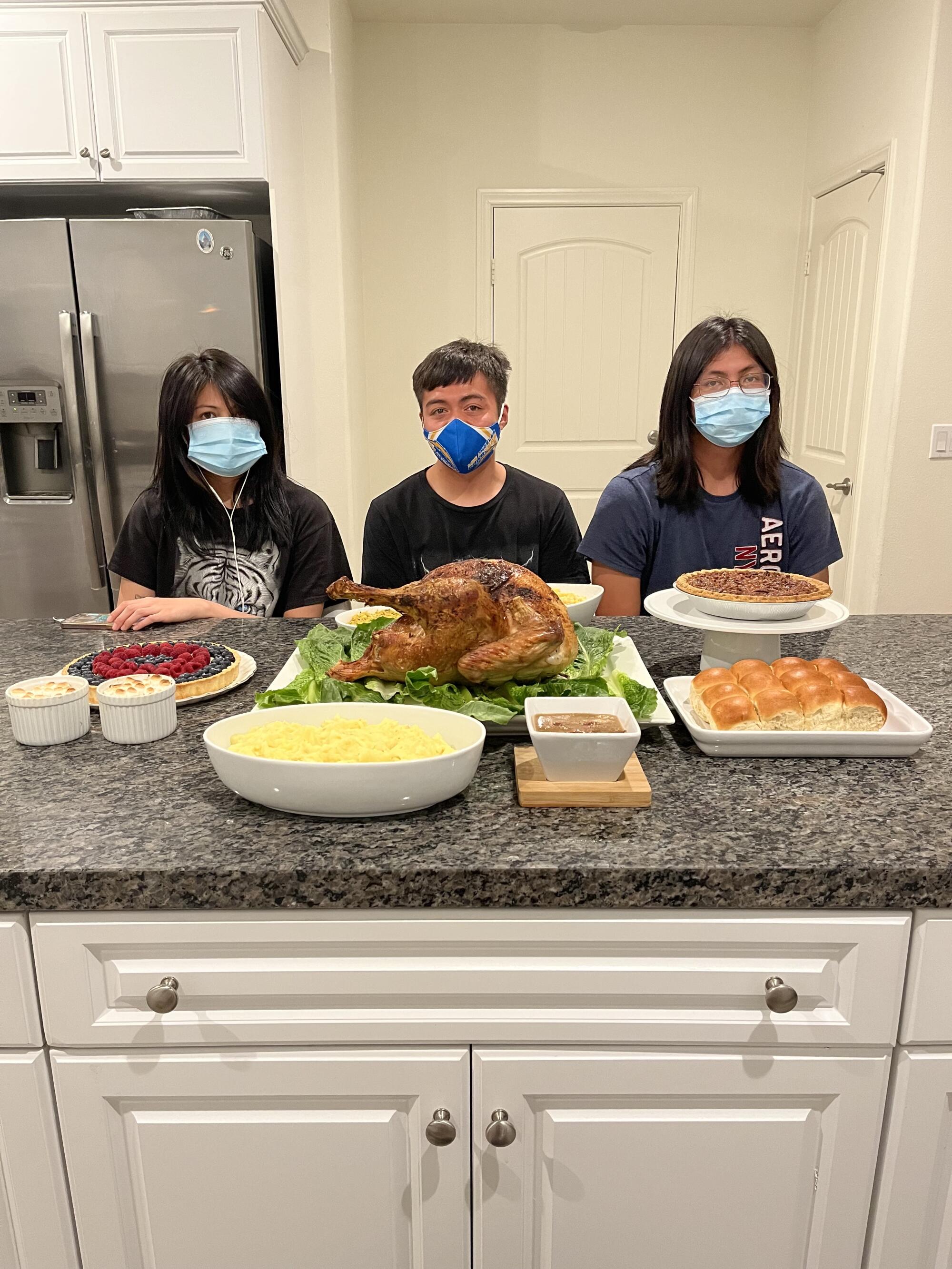 Giancarlo Santos' children mask up for Thanksgiving at the family's home in Chino.