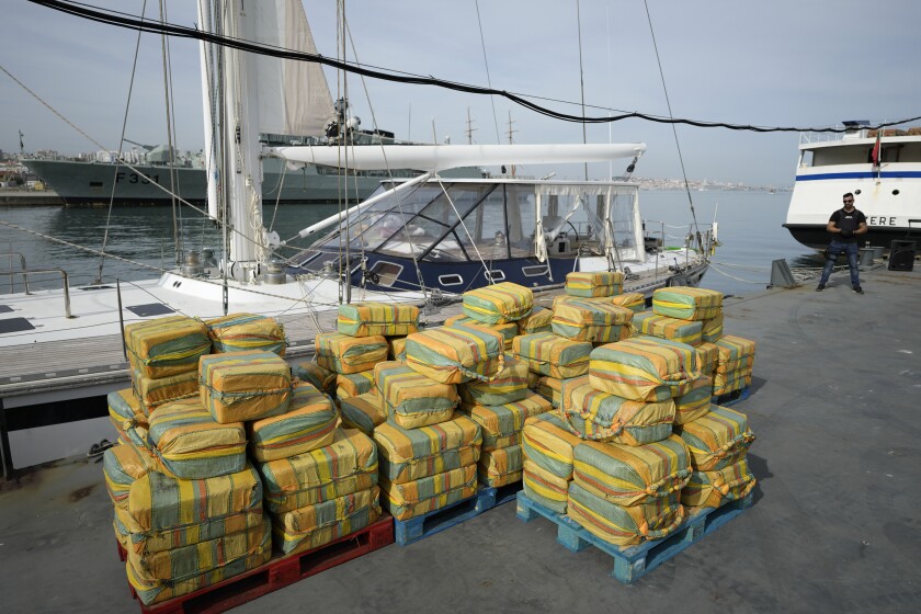 FILE - Bales of cocaine weighting some 5,2 tons and a seized yacht are displayed for the media at a Portuguese Navy base in Almada, south of Lisbon, on Oct. 18, 2021. Records amounts of cocaine are being seized in Europe while manufacturing of the banned stimulant drug is now taking place inside the the European Union, officials in charge of fighting and monitoring drugs use in the bloc warned on Friday, May 6, 2022. (AP Photo/Armando Franca)