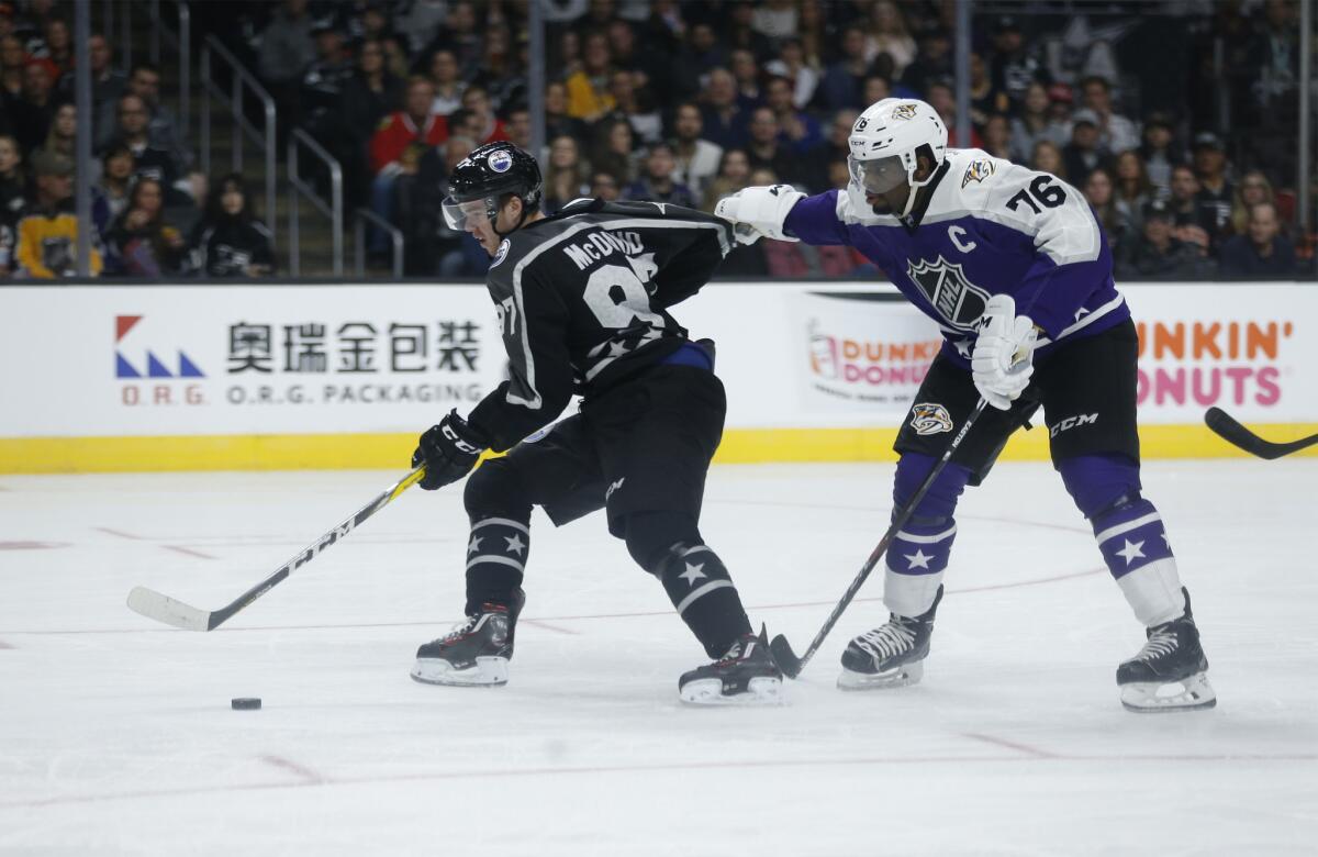 Predators defenseman P.K. Subban, right, makes it difficult for Oilers forward Connor McDavid to go on a breakaway during the NHL All-Star game at Staples Center on Sunday.