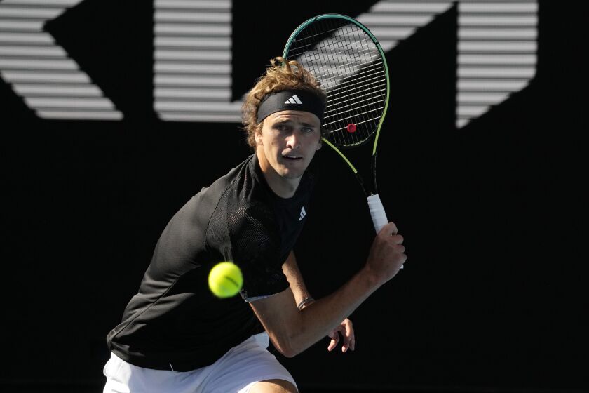 Alexander Zverev of Germany plays a backhand return to Michael Mmoh of the U.S. during their second round match at the Australian Open tennis championship in Melbourne, Australia, Thursday, Jan. 19, 2023. (AP Photo/Ng Han Guan)