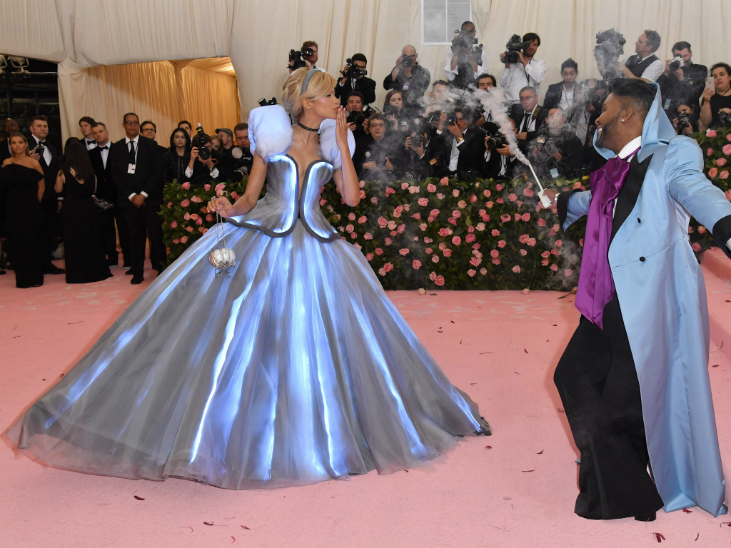 Zendaya went full Cinderella in a light-up Tommy Hilfiger gown with stylist Law Roach (with smoking wand, right) playing the role of the transformative fairy godmother. Zendaya was already on our list of favorites -- even before she left a glass slipper on the pink carpet on the way into the gala.