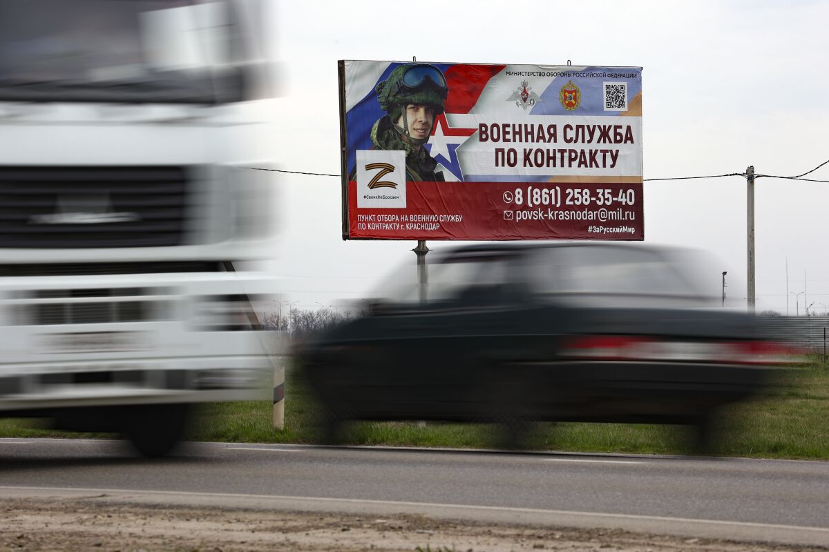 A billboard advertising "Contract military service" is seen beside a highway outside Krasnodar, Russia, Thursday, March 23, 2023. A campaign to replenish Russian troops in Ukraine with more soldiers appears to be underway again, with makeshift recruitment centers popping up in cities and towns, and state institutions posting ads promising cash bonuses and benefits to entice men to sign contracts enabling them to be sent into the battlefield. (AP Photo)