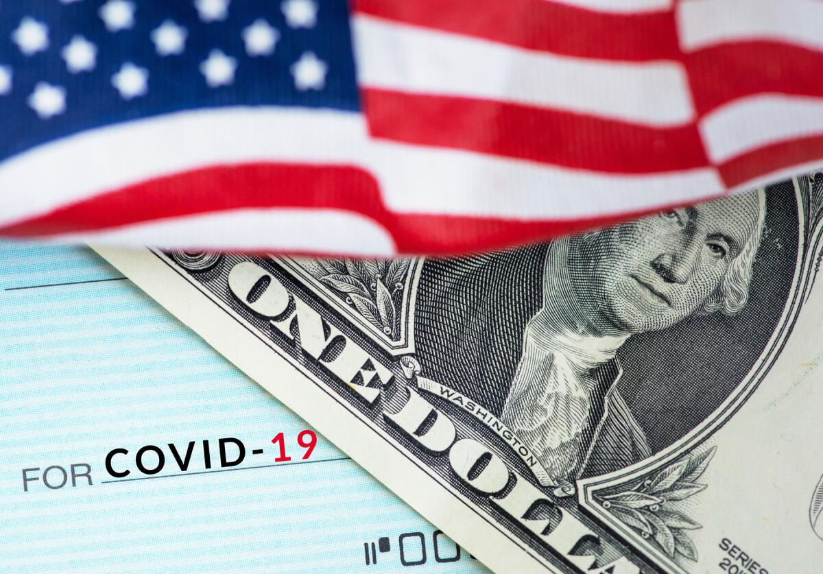 A dollar bill, Covid-19 check, American flag