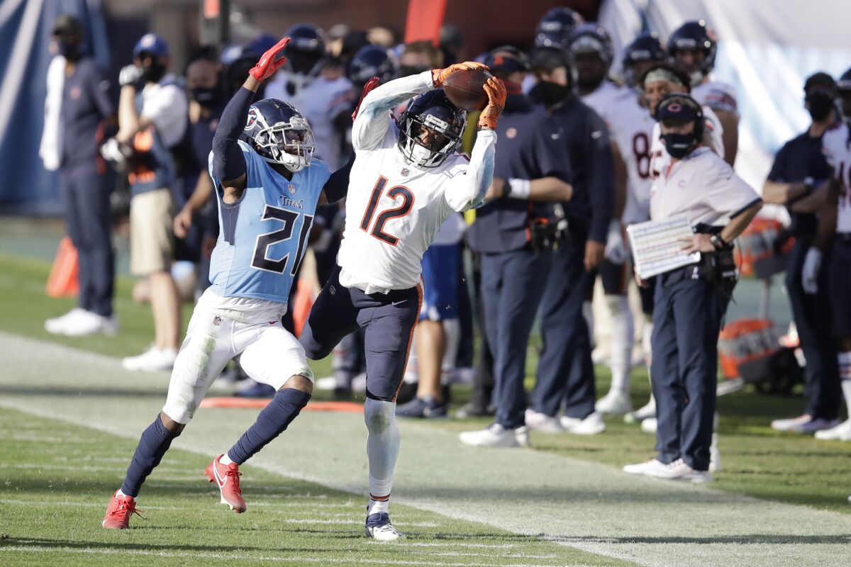 Chicago Bears wide receiver Allen Robinson (12) catches a pass as he is defended by Tennessee Titans cornerback Malcolm Butler (21) in the second half of an NFL football game Sunday, Nov. 8, 2020, in Nashville, Tenn. (AP Photo/Ben Margot)